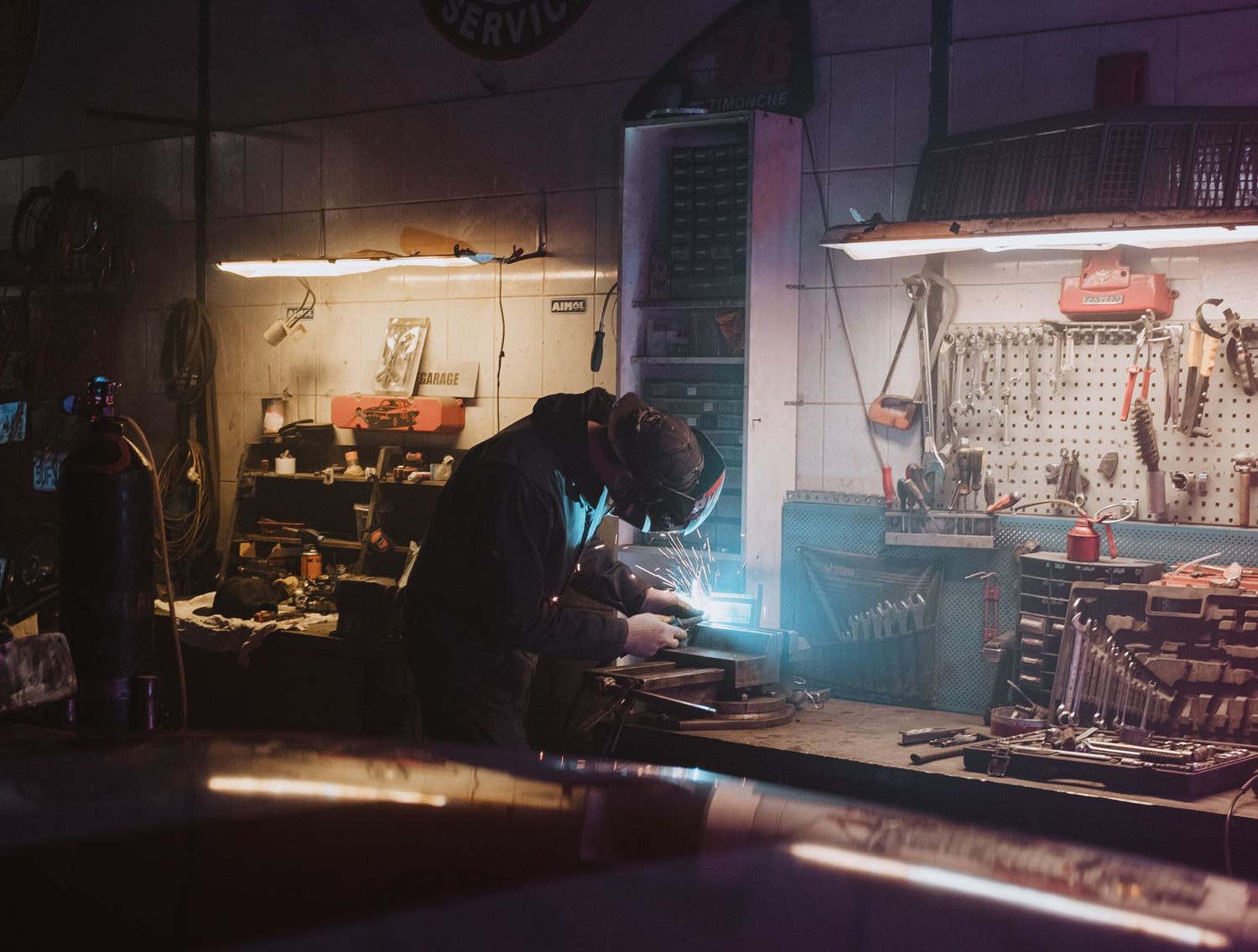 Mechanic in workshop performing repairs using Blue Truck Parts